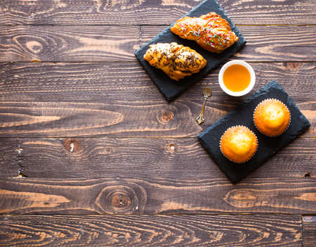Delicious homemade muffins with yogurt, on a wooden background with space for text. Top viewの写真素材
