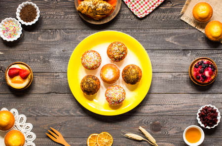 Delicious homemade muffins with yogurt, on a wooden background with space for text. Top viewの写真素材