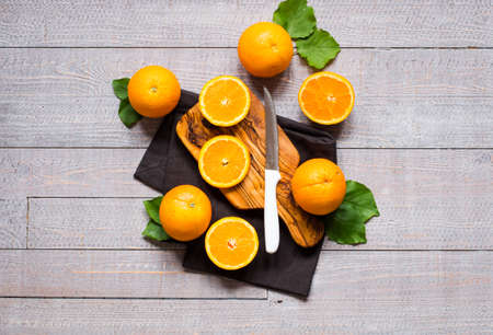 Fresh orange with leaves on wooden background. Top view, copy spaceの写真素材