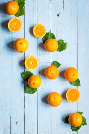 Fresh orange with leaves on wooden background. Top view, copy spaceの写真素材