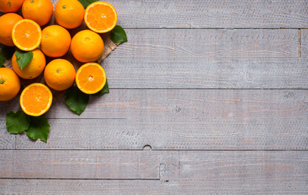 Fresh orange with leaves on wooden background. Top view, copy space