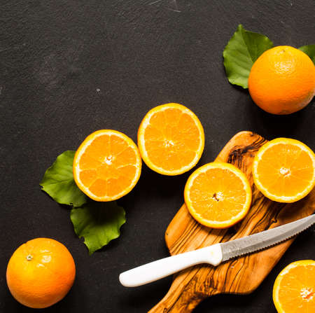 Fresh orange with leaves on wooden background. Top view, copy spaceの写真素材