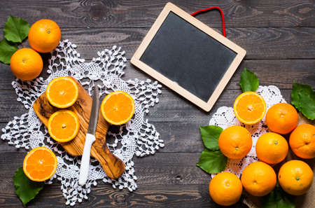 Fresh orange with leaves on wooden background. Top view, copy spaceの写真素材
