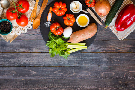 Different types of vegetables, on a old wooden table, space for text. Top view