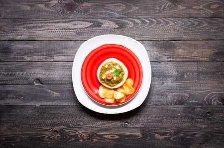tasty and delicious bruschetta with avocado, tomatoes, cheese, herbs, chips and liquor, on a wooden background. Top viewの写真素材