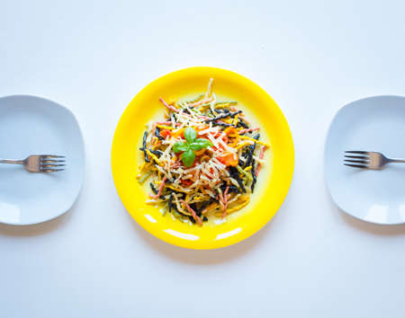 Delicious pasta with fresh vegetables and cheese, on a wooden background . Top viewの写真素材