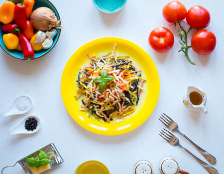 Delicious pasta with fresh vegetables and cheese, on a wooden background . Top viewの写真素材