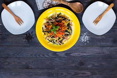 Delicious pasta with fresh vegetables and cheese, on a wooden background . Top viewの写真素材