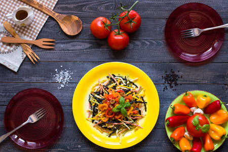 Delicious pasta with fresh vegetables and cheese, on a wooden background . Top viewの写真素材