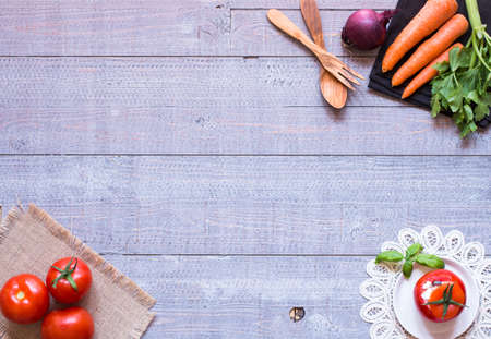 Stuffed tomatoes with cheese, and different vegetables, on a wooden background, free space for text.の写真素材