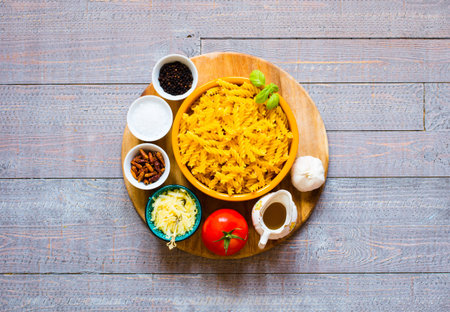 Fusilli pasta with tomato sauce, tomatoes, onion, garlic, dried paprika, olives, pepper and olive...