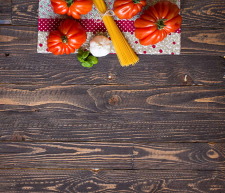Ox heart tomatoes, on rustic wood background, free space for text. Top viewの写真素材