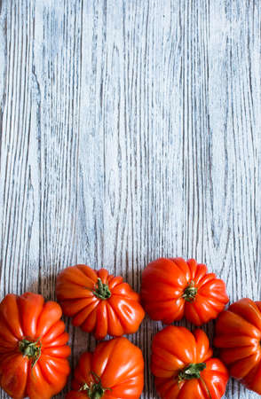 Ox heart tomatoes, on rustic wood background, free space for text. Top viewの写真素材