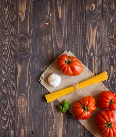 Ox heart tomatoes, on rustic wood background, free space for text. Top viewの写真素材