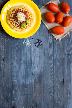 Top view of Italian pasta rigatoni with bolognese sauce, on a rustic wooden background. Top viewの写真素材