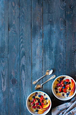 Healthy breakfast with milk,muesli and fruit, on a wooden background. Top view