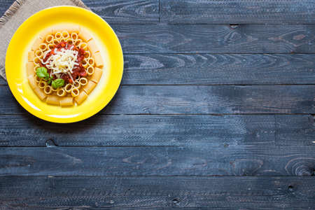 Top view of Italian pasta rigatoni with bolognese sauce, on a rustic wooden background. Top viewの写真素材