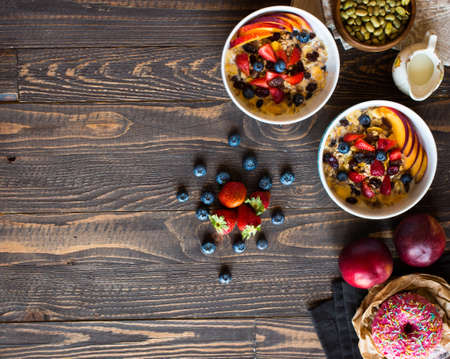 Healthy breakfast with milk,muesli and fruit, on a wooden background. Top viewの写真素材