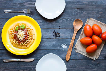Top view of Italian pasta rigatoni with bolognese sauce, on a rustic wooden background. Top viewの写真素材