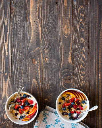 Healthy breakfast with milk,muesli and fruit, on a wooden background. Top viewの写真素材