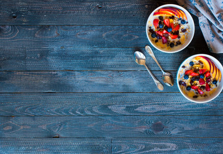 Healthy breakfast with milk,muesli and fruit, on a wooden background. Top viewの写真素材