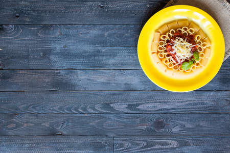 Top view of Italian pasta rigatoni with bolognese sauce, on a rustic wooden background. Top viewの写真素材