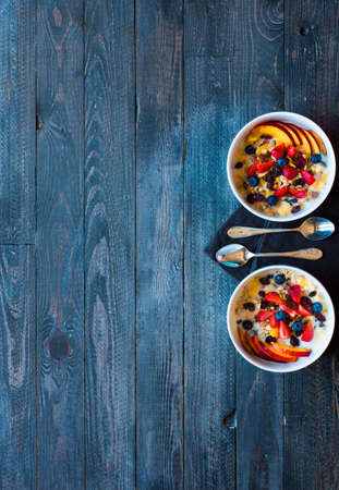 Healthy breakfast with milk,muesli and fruit, on a wooden background. Top viewの写真素材