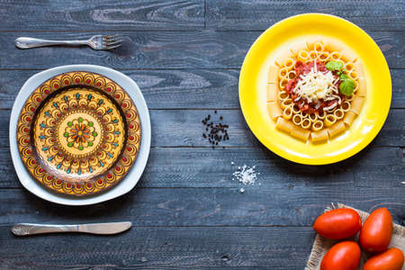 Top view of Italian pasta rigatoni with bolognese sauce, on a rustic wooden background. Top viewの写真素材