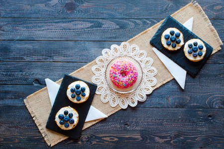 Delicious healthy breakfast, fruit sandwiches with different fillings, cheese, banana, strawberry, fishing, butter, blueberry, on a different wooden background. top viewの写真素材