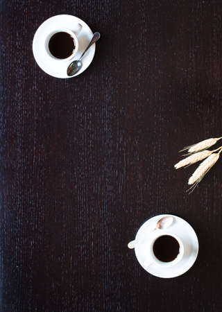 Coffee beans and cup of coffee with other components on different wooden background. Free space for textの写真素材