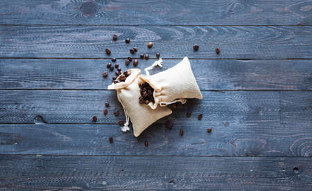Coffee beans and cup of coffee with other components on different wooden background. Free space for textの写真素材
