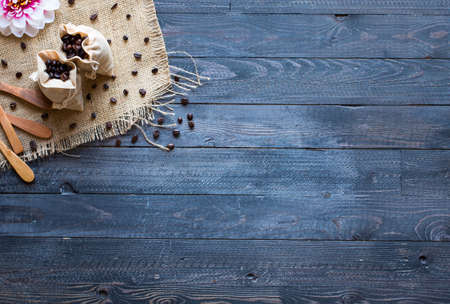Coffee beans and cup of coffee with other components on different wooden background. Free space for textの写真素材