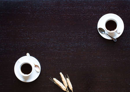 Coffee beans and cup of coffee with other components on different wooden background. Free space for textの写真素材