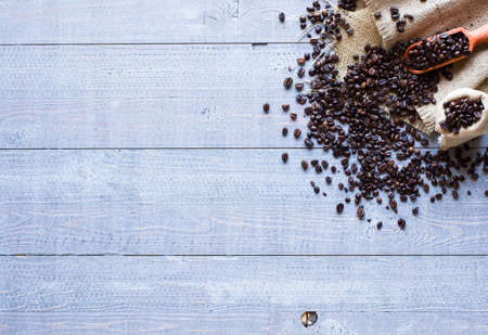 Coffee beans and cup of coffee with other components on different wooden background. free space for text. Top viewの写真素材