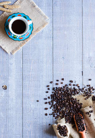 Coffee beans and cup of coffee with other components on different wooden background. free space for text. Top viewの写真素材