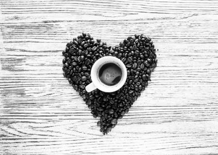 Coffee beans and cup of coffee with other components on different wooden background. free space for text. Top viewの写真素材