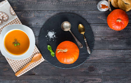 Homemade Pumpkin Soup on rustic wooden background, free space for text. Top viewの写真素材