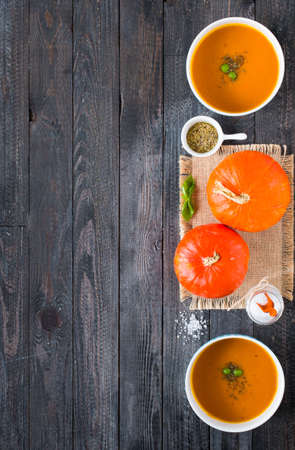 Homemade Pumpkin Soup on rustic wooden background, free space for text. Top viewの写真素材