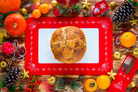 Traditional Italian Christmas cake with chocolate and various xmas decorations, free space for textの写真素材
