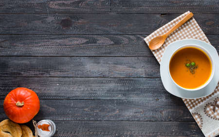 Homemade Pumpkin Soup on rustic wooden background, free space for text. Top viewの写真素材