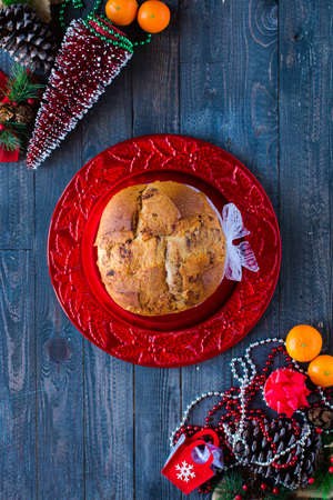Traditional Italian Christmas cake with chocolate and various xmas decorations, free space for textの写真素材