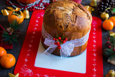 Traditional Italian Christmas cake with chocolate and various xmas decorations, free space for textの写真素材