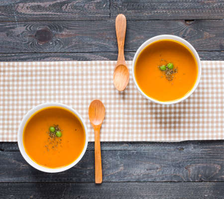 Homemade Pumpkin Soup on rustic wooden background, free space for text. Top viewの写真素材