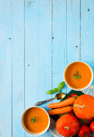 Homemade Pumpkin Soup on rustic wooden background, free space for text. Top viewの写真素材