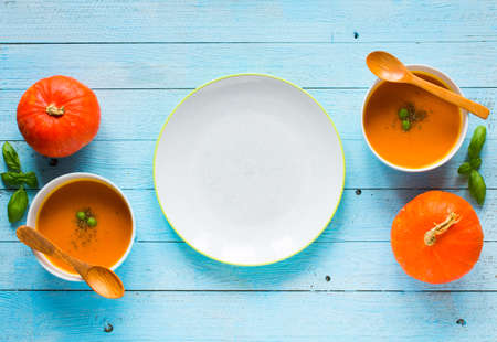 Homemade Pumpkin Soup on rustic wooden background, free space for text. Top viewの写真素材