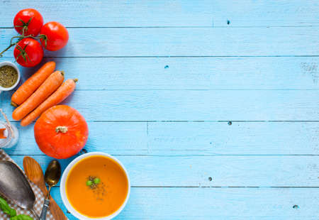 Homemade Pumpkin Soup on rustic wooden background, free space for text. Top viewの写真素材