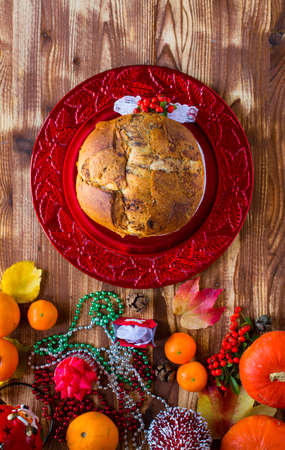 Traditional Italian Christmas cake with chocolate and various xmas decorations, free space for textの写真素材