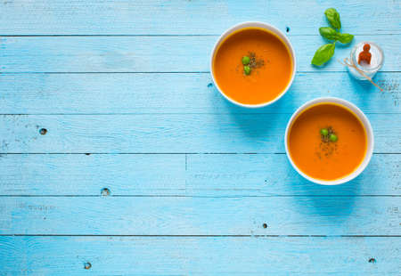 Homemade Pumpkin Soup on rustic wooden background, free space for text. Top viewの写真素材