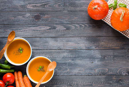 Homemade Pumpkin Soup on rustic wooden background, free space for text. Top viewの写真素材