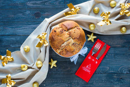 Traditional Italian Christmas cake with chocolate and various xmas decorations, free space for textの写真素材